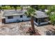 Charming single story home featuring a screen porch and tropical landscaping at 922 Alcazar S Way, St Petersburg, FL 33705