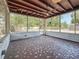 Spacious screened porch featuring decorative tile flooring, wood beamed ceiling, and a ceiling fan at 922 Alcazar S Way, St Petersburg, FL 33705