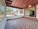 View of screened porch with decorative tile flooring, red wood beamed ceiling, and steps to back of house at 922 Alcazar S Way, St Petersburg, FL 33705