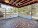Large screened porch with decorative tile flooring, wood beamed ceiling, and view of fenced backyard at 922 Alcazar S Way, St Petersburg, FL 33705
