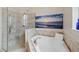 Bathroom featuring a shower, soaking tub, and marble accents at 109 S Packwood Ave # B, Tampa, FL 33606