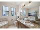 Bathroom featuring double sinks with granite counters, natural lighting, and a separate tub and shower at 109 S Packwood Ave # B, Tampa, FL 33606