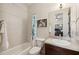A well-lit bathroom features a shower-tub combo and single sink vanity with a large mirror at 109 S Packwood Ave # B, Tampa, FL 33606