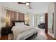 Bedroom featuring hardwood flooring, ceiling fan, seating area, and ample natural light at 109 S Packwood Ave # B, Tampa, FL 33606
