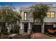 Charming townhome featuring a private entrance with a balcony, garage, and mature landscaping at 109 S Packwood Ave # B, Tampa, FL 33606