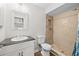 Updated bathroom features a shower and a vanity with a decorative, mosaic-framed mirror at 10900 Livingston Dr, New Port Richey, FL 34654