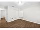 Bright bedroom features recessed lighting, closet space, and dark wood-look flooring at 10900 Livingston Dr, New Port Richey, FL 34654