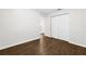 Bedroom with dark wood-look floors, closet and windows with natural light at 10900 Livingston Dr, New Port Richey, FL 34654