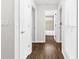 Hallway with dark wood-look flooring leads to other rooms, including a bathroom at 10900 Livingston Dr, New Port Richey, FL 34654