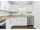 Bright kitchen featuring granite countertops, stainless steel appliances, and white cabinetry at 10900 Livingston Dr, New Port Richey, FL 34654