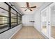 The bright lanai features tile floors, a ceiling fan, and lots of windows at 10900 Livingston Dr, New Port Richey, FL 34654