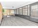 Screened lanai with plank flooring for enjoying the outdoors in comfort at 10900 Livingston Dr, New Port Richey, FL 34654