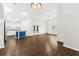 Open concept living area with modern lighting, wood-look floors, and access to the kitchen at 10900 Livingston Dr, New Port Richey, FL 34654