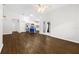 Open concept living area with modern lighting, wood-look floors, and access to the kitchen at 10900 Livingston Dr, New Port Richey, FL 34654