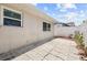 Cracked concrete patio with a white fence provides a cozy outdoor area at 10900 Livingston Dr, New Port Richey, FL 34654