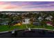 Breathtaking aerial view of a waterfront home with lush landscaping, private boat dock, and a serene pool at 110 Carlyle Dr, Palm Harbor, FL 34683