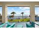 View of waterfront from covered balcony with rocking chairs on sunny day at 110 Carlyle Dr, Palm Harbor, FL 34683