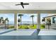 Covered balcony provides views of waterfront, palm trees and a blue sky at 110 Carlyle Dr, Palm Harbor, FL 34683