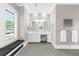 Bright bathroom with white cabinetry, a vanity and window seat below a bright window at 110 Carlyle Dr, Palm Harbor, FL 34683