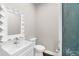 Charming powder room with a decorative mirror, modern fixtures, and unique blue glass door at 110 Carlyle Dr, Palm Harbor, FL 34683