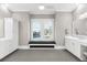 Bright and open bathroom featuring double vanities, a window seat and tile floors at 110 Carlyle Dr, Palm Harbor, FL 34683