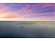 Stunning beach view at sunset with beautiful purple and orange skies over calm waters at 110 Carlyle Dr, Palm Harbor, FL 34683