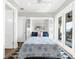 Comfortable bedroom featuring built-in shelving, decorative pillows, and a balcony with views at 110 Carlyle Dr, Palm Harbor, FL 34683