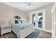 Bedroom with water views from French doors and beach themed decor at 110 Carlyle Dr, Palm Harbor, FL 34683