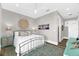 Bright bedroom with a decorative rug, light-toned walls, and view to an open doorway at 110 Carlyle Dr, Palm Harbor, FL 34683