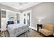 Well-lit bedroom with wood floors, a cozy chair, and a balcony overlooking the water at 110 Carlyle Dr, Palm Harbor, FL 34683