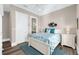 Comfortable bedroom with white trim and coastal decor, featuring a glimpse of an en suite bathroom at 110 Carlyle Dr, Palm Harbor, FL 34683