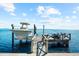 Waterfront property with private boat lift and dock for easy access to boating and water activities at 110 Carlyle Dr, Palm Harbor, FL 34683