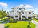 Beautiful white home with lush green lawn and two-car garage, perfect for Gathering living at 110 Carlyle Dr, Palm Harbor, FL 34683