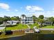 Waterfront estate with lush landscaping, pool, and private dock offering direct access to the water at 110 Carlyle Dr, Palm Harbor, FL 34683