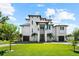 Stunning multi-story modern home featuring manicured lawn and two-car garage in a desirable neighborhood at 110 Carlyle Dr, Palm Harbor, FL 34683