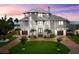 Beautiful three-story home featuring meticulously landscaped grounds, a three-car garage, and central entry at 110 Carlyle Dr, Palm Harbor, FL 34683