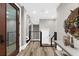 Bright and inviting hallway with hardwood floors, modern fixtures, and staircase access at 110 Carlyle Dr, Palm Harbor, FL 34683