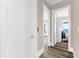 Hallway showing wood floors and access to bedrooms with an ocean view at 110 Carlyle Dr, Palm Harbor, FL 34683