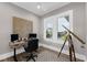 Bright home office with a ceiling fan, modern desk, and view of the outdoors from the bright windows at 110 Carlyle Dr, Palm Harbor, FL 34683