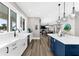Bright kitchen featuring a farmhouse sink, white cabinets, and views of the water at 110 Carlyle Dr, Palm Harbor, FL 34683