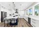 Modern kitchen featuring white cabinets, stainless steel appliances, a blue island, and pendant lighting at 110 Carlyle Dr, Palm Harbor, FL 34683