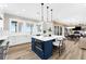Bright, modern kitchen with a large island, pendant lighting, and views of the ocean at 110 Carlyle Dr, Palm Harbor, FL 34683
