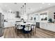 Modern kitchen featuring white cabinets, stainless steel appliances, a blue island, and pendant lighting at 110 Carlyle Dr, Palm Harbor, FL 34683