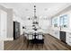 Modern kitchen featuring white cabinets, stainless steel appliances, a blue island, and pendant lighting at 110 Carlyle Dr, Palm Harbor, FL 34683