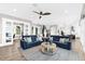 Open concept living room with luxury vinyl flooring, a ceiling fan, and comfortable seating area at 110 Carlyle Dr, Palm Harbor, FL 34683