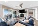 Inviting living room featuring a cozy fireplace, waterfront view, and neutral color palette at 110 Carlyle Dr, Palm Harbor, FL 34683
