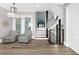 Bright and airy living room featuring wood floors, stairs, and natural light at 110 Carlyle Dr, Palm Harbor, FL 34683