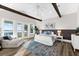 Serene main bedroom with vaulted ceilings, wood beams, and access to a balcony at 110 Carlyle Dr, Palm Harbor, FL 34683