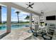 Back patio featuring an outdoor dining area with a pool and bay view at 110 Carlyle Dr, Palm Harbor, FL 34683
