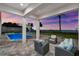 Covered patio with outdoor seating and a pool, offering stunning views of the ocean at 110 Carlyle Dr, Palm Harbor, FL 34683